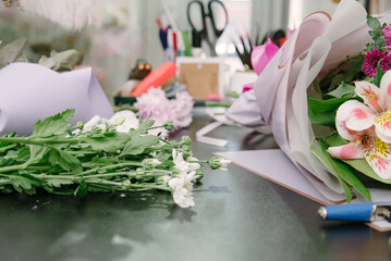 Florist equipment with flowers on wooden background