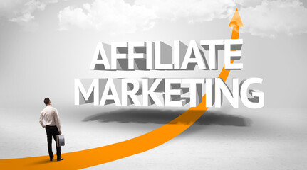Rear view of a businessman standing in front of AFFILIATE MARKETING inscription, successful business concept