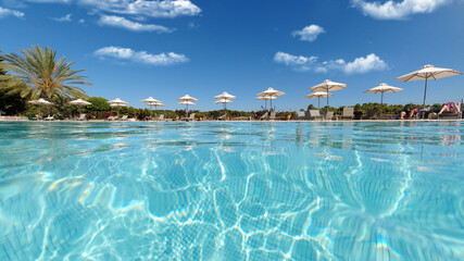 Fototapeta na wymiar Underwater split photo of paradise turquoise pool as seen in exotic resort