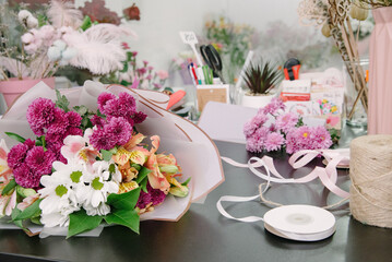 Florist equipment with flowers on wooden background