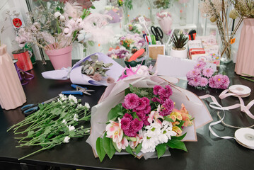 Florist equipment with flowers on wooden background