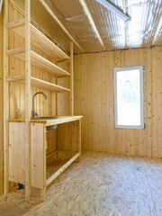 Construction of a country house. Installed homemade yet stylish wood kitchen