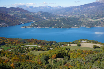 bird eye view of Serre Ponçon lake, France in the fall on a glorious blue day