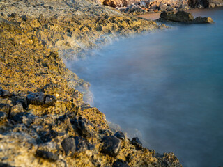 rocks on a beach and moving water
