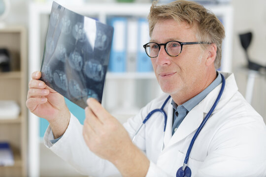 senior man medical doctor looking at x-rays in a hospital