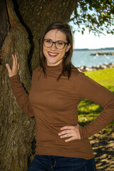 Young Woman Standing Next to a Tree