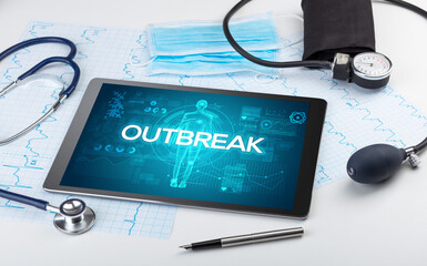 Tablet pc and doctor tools with OUTBREAK inscription, coronavirus concept