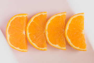 Elegant orange slices on a pink silk tablecloth adorned with white napkins at the ends. Digestive desserts in restaurants.
