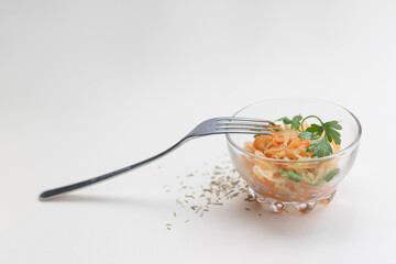  fermented cabbage in a glass bowl on a light background, rosemary on the table