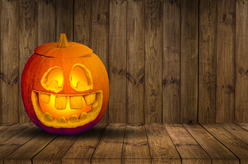 One spooky halloween pumpkin, Jack O Lantern, with an evil face and eyes on a wooden bench, table with a misty gray coastal night background with space for product placement.
