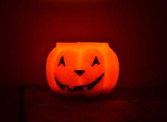 Festive orange candle pumpkin at night in the hands. Magic. Shine. Halloween. postcard, headband.