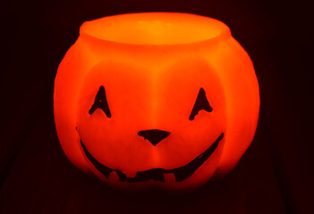 Festive orange candle pumpkin at night in the hands. Magic. Shine. Halloween. postcard, headband.