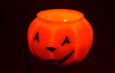 Festive orange candle pumpkin at night in the hands. Magic. Shine. Halloween. postcard, headband.