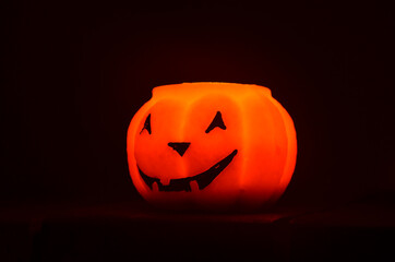 Festive orange candle pumpkin at night in the hands. Magic. Shine. Halloween. postcard, headband.