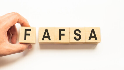 Word fafsa. Wooden small cubes with letters isolated on white background with copy space available