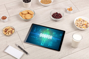 DOCTOR concept in tablet with fruits, top view