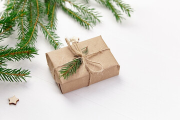 Naklejka na ściany i meble Decorated gift box with christmas tree branches.