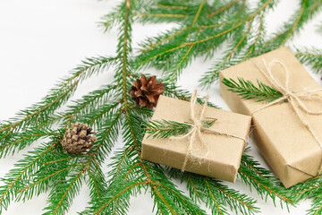 Fototapeta na wymiar Christmas gift boxes and fir tree branches on white background.