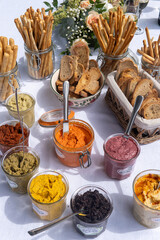 Home made lunch for celebration with bread and colorful and healthy seasonning: hummus, olives, beans...
Home made labels with written in french the ingredients: 