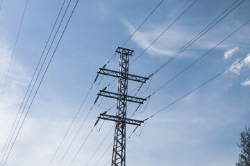 Energy distribution high voltage power line tower with wires and trees