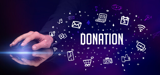 hand holding wireless peripheral with DONATION inscription, social media concept