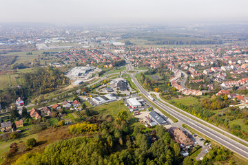 Fototapeta na wymiar Drone photo of a roundabout in Csacs district on a foggy autumn morning in City Zalaegerszeg, Hungary
