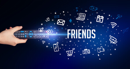hand holding wireless peripheral with FRIENDS inscription, social media concept