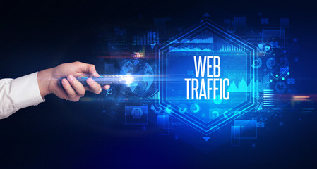 hand holding wireless peripheral with WEB TRAFFIC inscription, cyber security concept