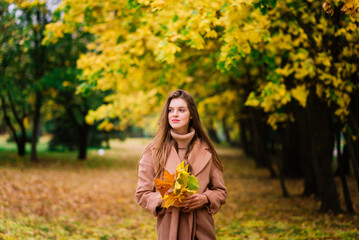 Beautiful woman spending time in park during autumn season