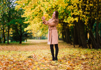 Beautiful woman spending time in park during autumn season