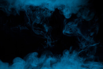 Abstract blue smoke moves on black background. Swirling smoke.
