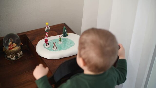 A boy plays with ceramic figures for Christmas