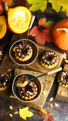 Selective focus. Pumpkin cupcakes with chocolate. Autumn desserts. Autumn still life with delicious pumpkin muffins.