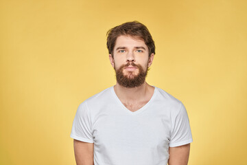 Fototapeta premium Bearded man on emotions white t-shirt fun lifestyle yellow background
