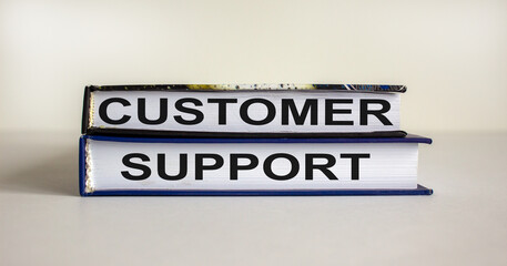 Books with text 'customer support' on beautiful white background. Business concept. Copy space.