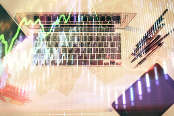 Multi exposure of forex chart drawing over table background with computer. Concept of financial research and analysis. Top view.