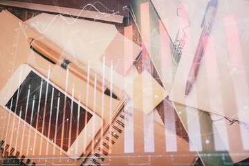 Multi exposure of forex graph hologram over desktop with phone. Top view. Mobile trade platform...