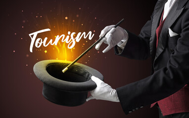 Magician is showing magic trick with Tourism inscription, traveling concept