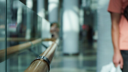 Wooden railings and glass wall in a large shopping center for the comfort of shoppers, modern design.Close-up, selective focus, blur