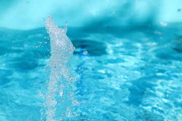 Fountain and splashes on a background of blue water