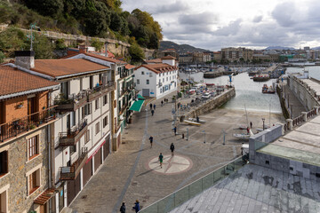 Fototapeta na wymiar People walking around the maritime port of the old quarter of San Sebastian, Basque country.
