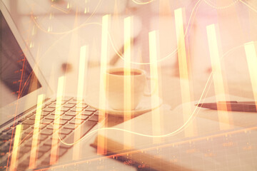 Double exposure of financial chart drawing and desktop with coffee and items on table background....