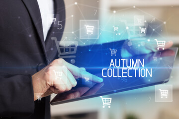 Young person makes a purchase through online shopping application with AUTUMN COLLECTION inscription
