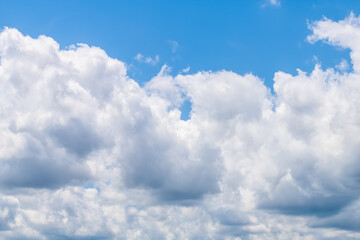 Naklejka na ściany i meble Isolated white large cloud formations closeup in blue sky cloudscape skyscape looking up during day in Tampa, Florida