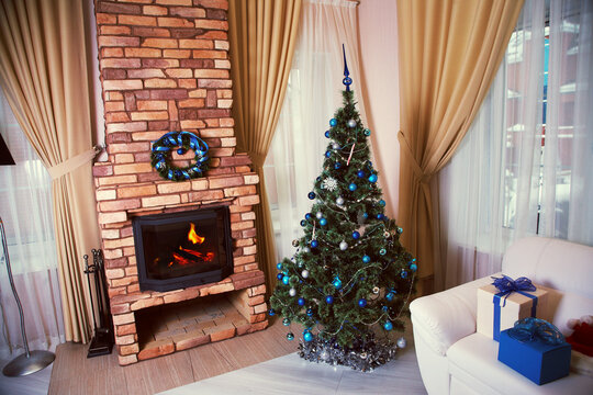 home interior with decorated fireplace and christmas tree