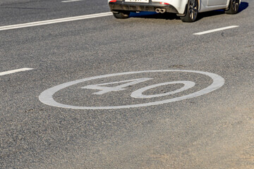The speed limit sign is applied to the asphalt. Traffic safety. Selective focus