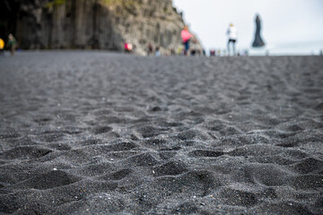 Iceland abstract view of rain on Reynisfjara black sand beach in Vik volcanic rock formations with...
