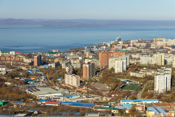 Naklejka na ściany i meble Vladivostok, Russia - October, 27, 2019: View of the industrial and residential areas of Vladivostok from the top of the Kholodilnik Hill.