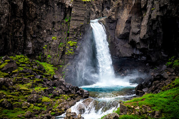 Fototapeta na wymiar Folaldafoss waterfall closeup of rocks and water fall in east Iceland cliff wall in Berufjordur area