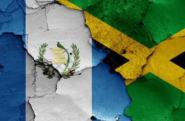 flags of Guatemala and Jamaica painted on cracked wall